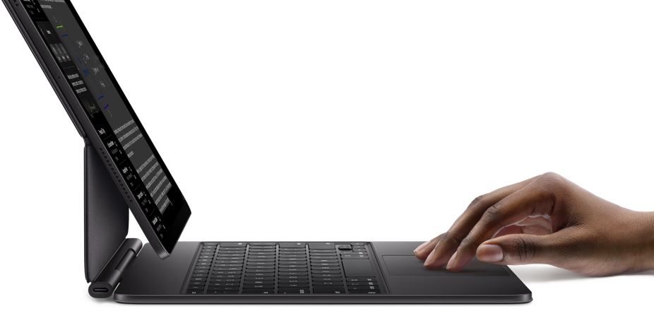 iPad Pro paired with iPad Magic Keyboard, hand using touchpad